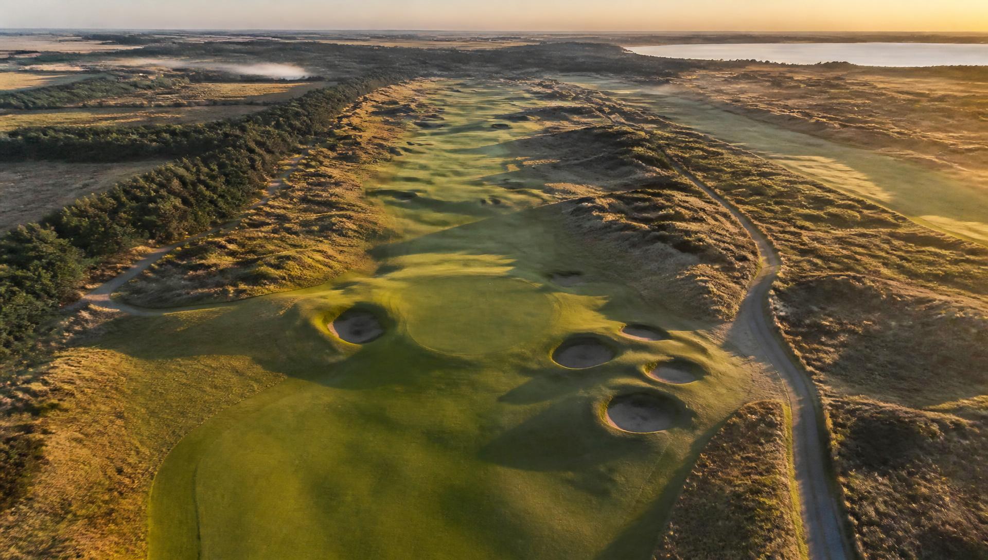 Aerial drone view of a links golf course at golden hour